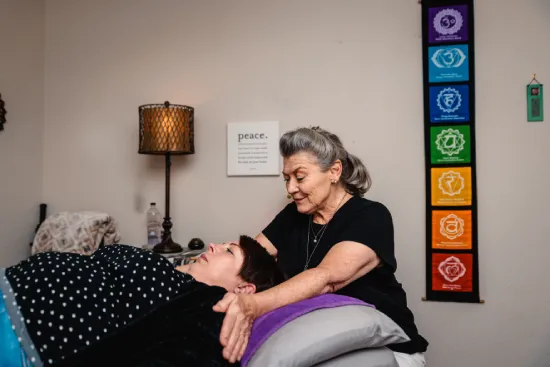 A woman receives a massage in a calm and soothing environment.