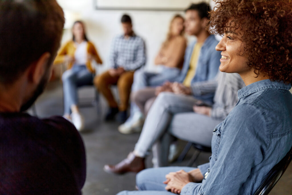 Happy woman attending a group therapy about Methadone Addiction